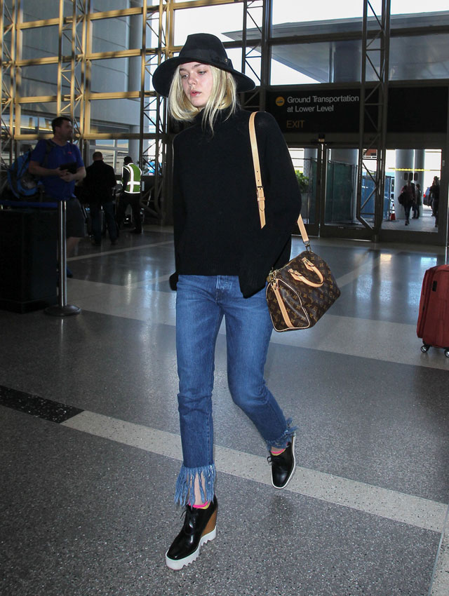 Elle Fanning's fringe jeans and turtleneck sweater look for less