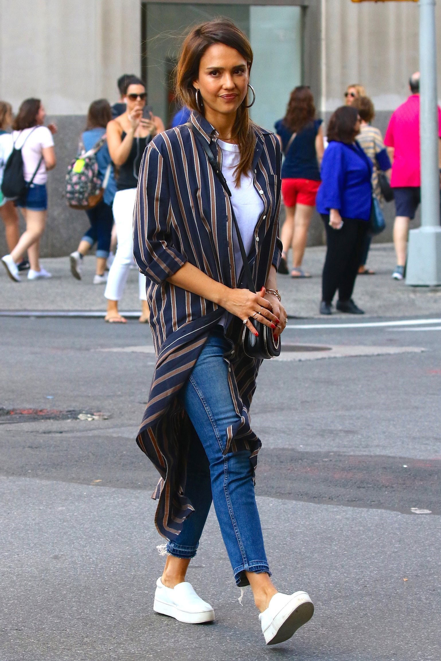Jessica Alba looks cute and casual in a stripe duster, white tee, jeans and white sneakers.