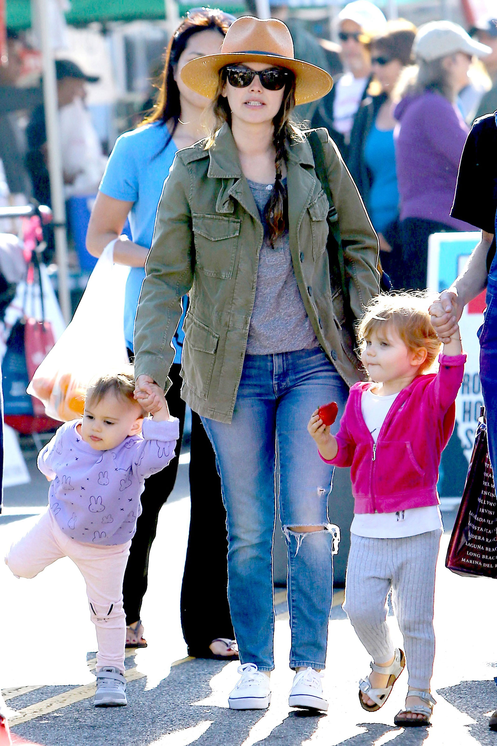 Rachel Bilson's casual mom style is cute and comfy, featuring a utility jacket, ripped jeans and white sneakers.