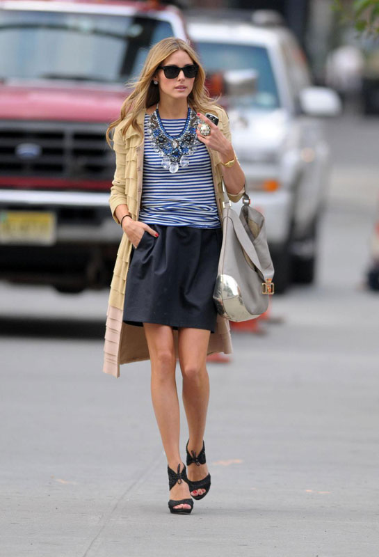 We're in love with Olivia Palermo's ruffle trench coat, striped top and statement necklace look.