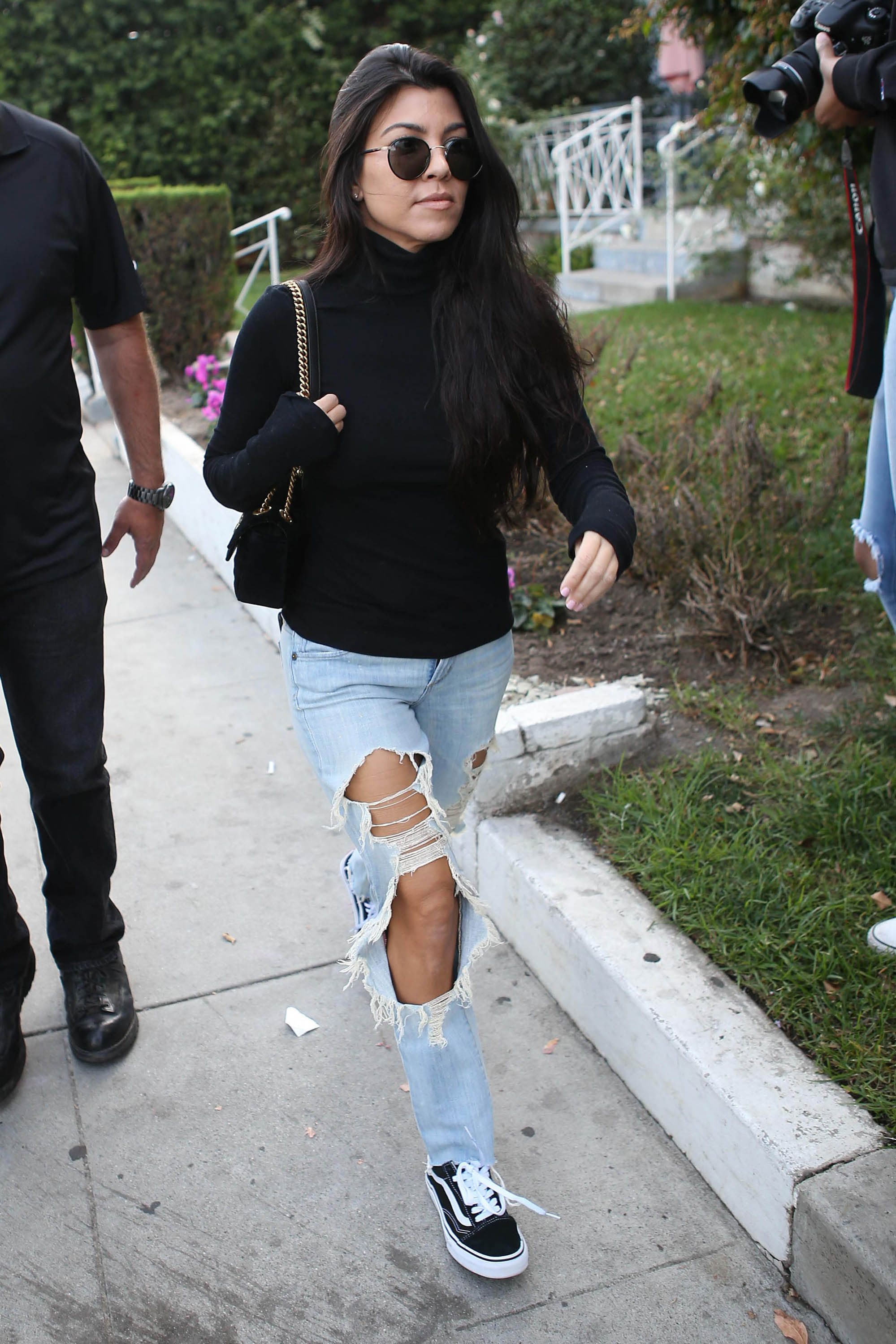 Shop Kourtney Kardashian's turtleneck top and destroyed jeans look for less.