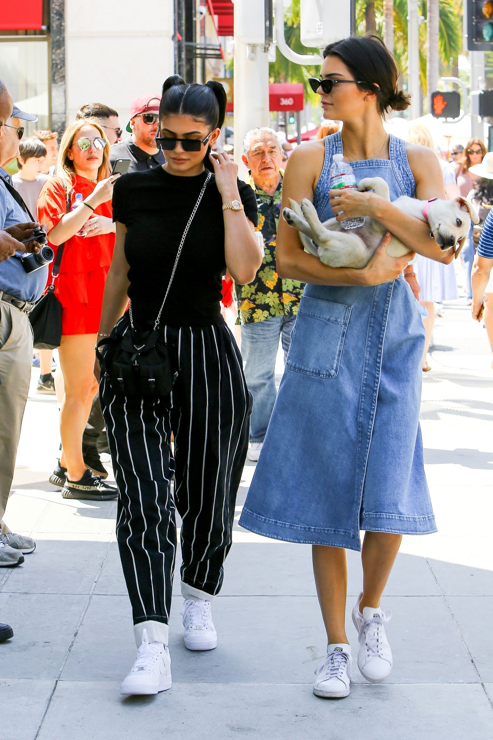 Kylie Jenner wears Celine vertical striped trousers while out and about with sister Kendall on Father's Day.