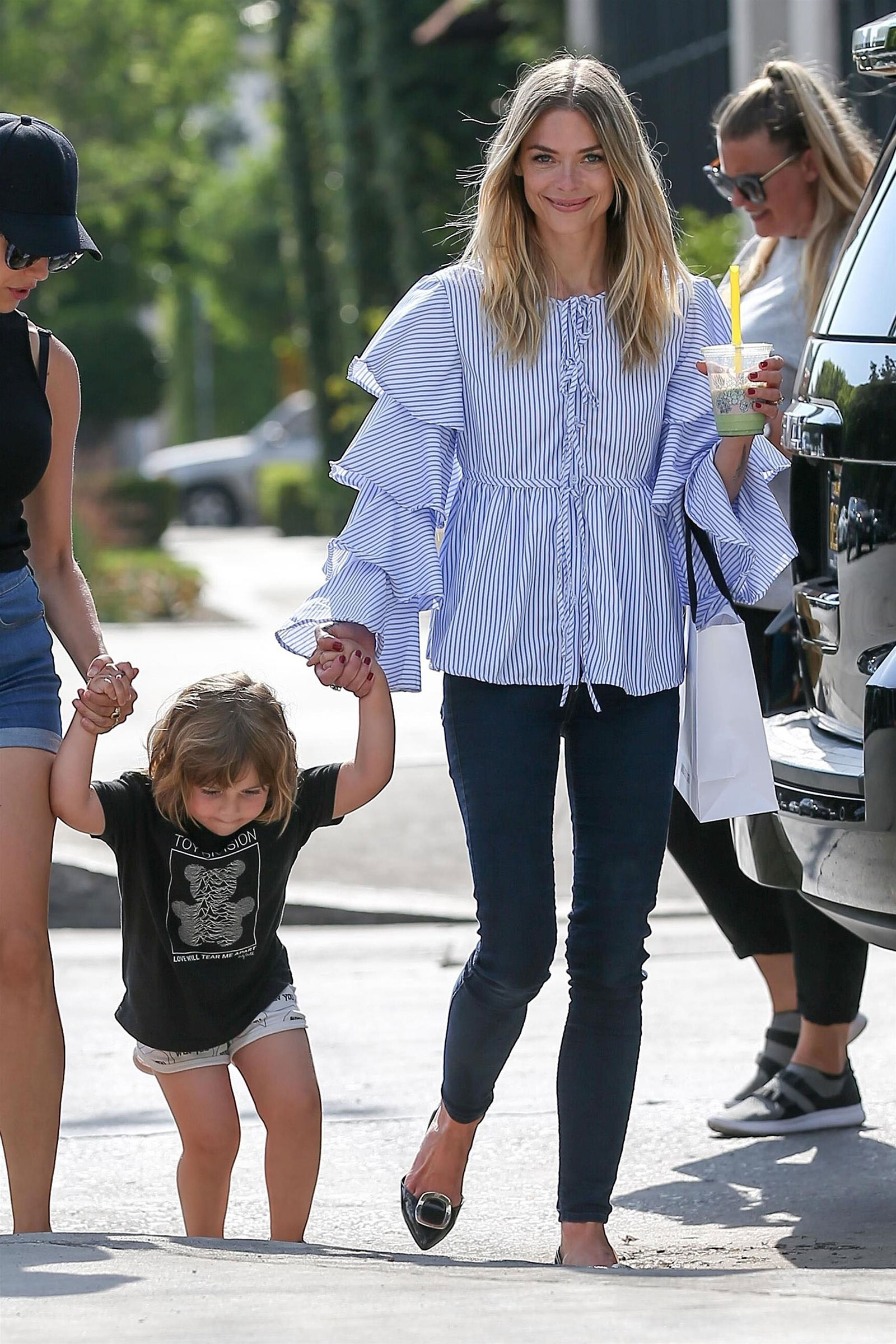 Jaime King wears a ruffle shirt and skinny jeans while shopping.