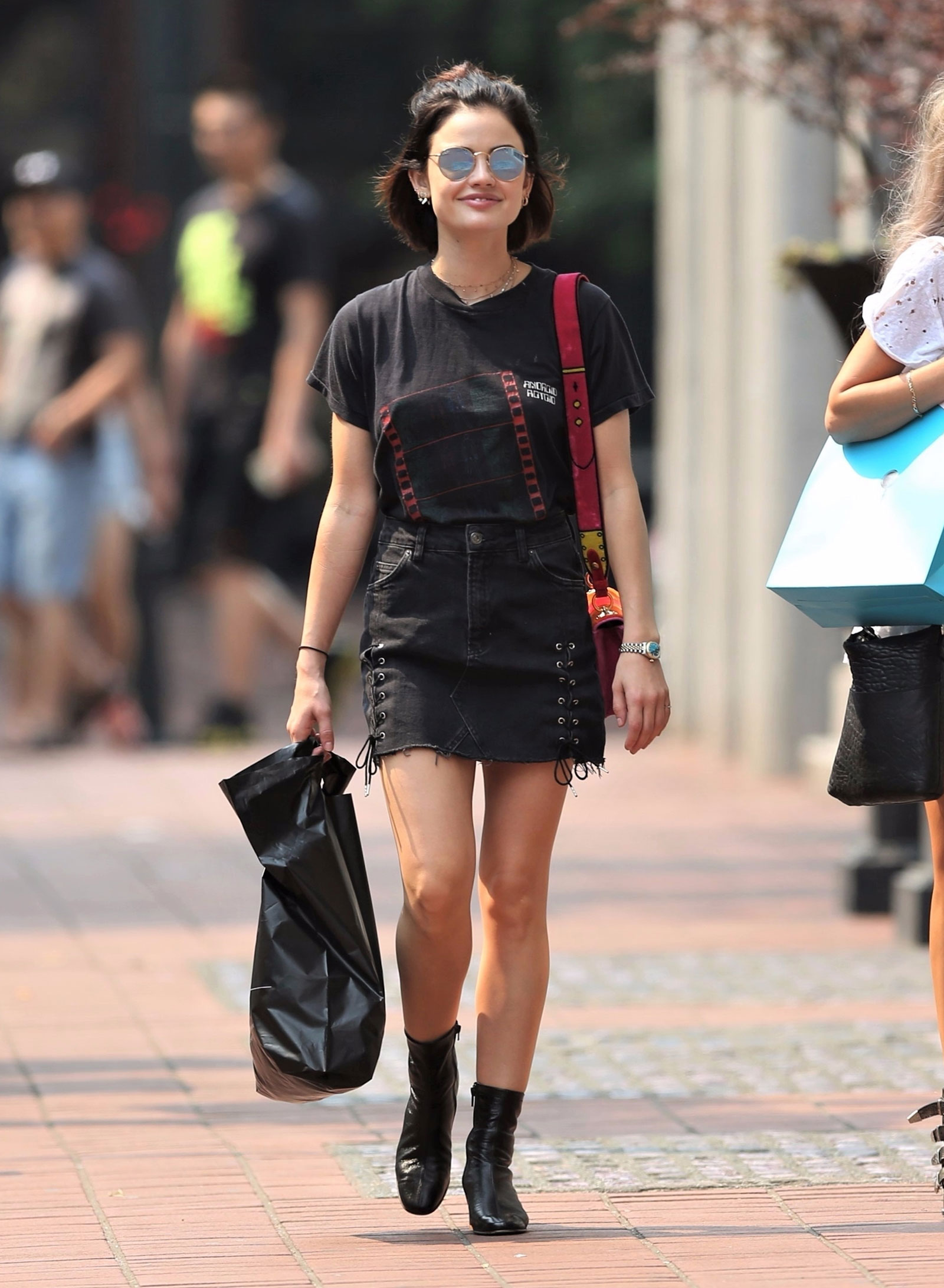 Lucy Hale steps out in a black denim mini and sock boots.