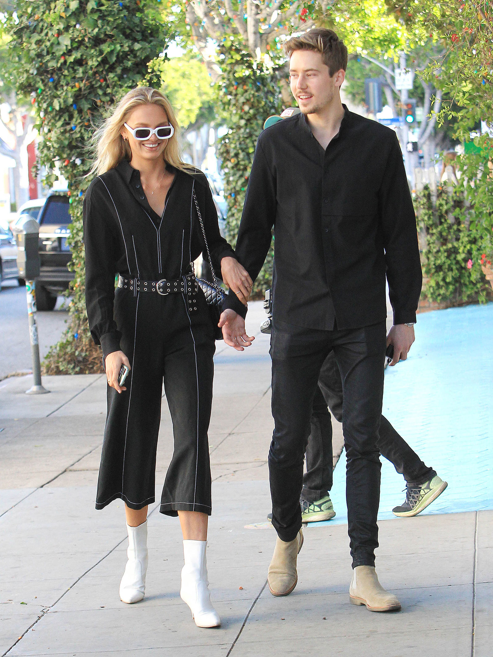 Romee Strijd's jumpsuit and white ankle boots look for less