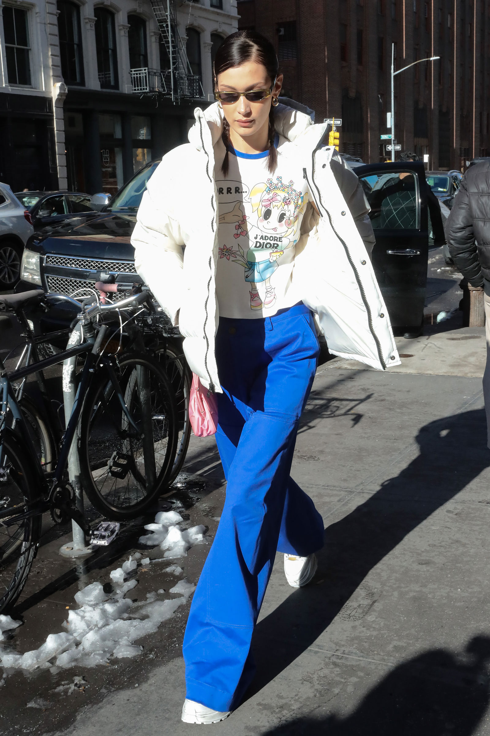 Bella Hadid's white puffer coat, blue pants and platform sneakers look for less