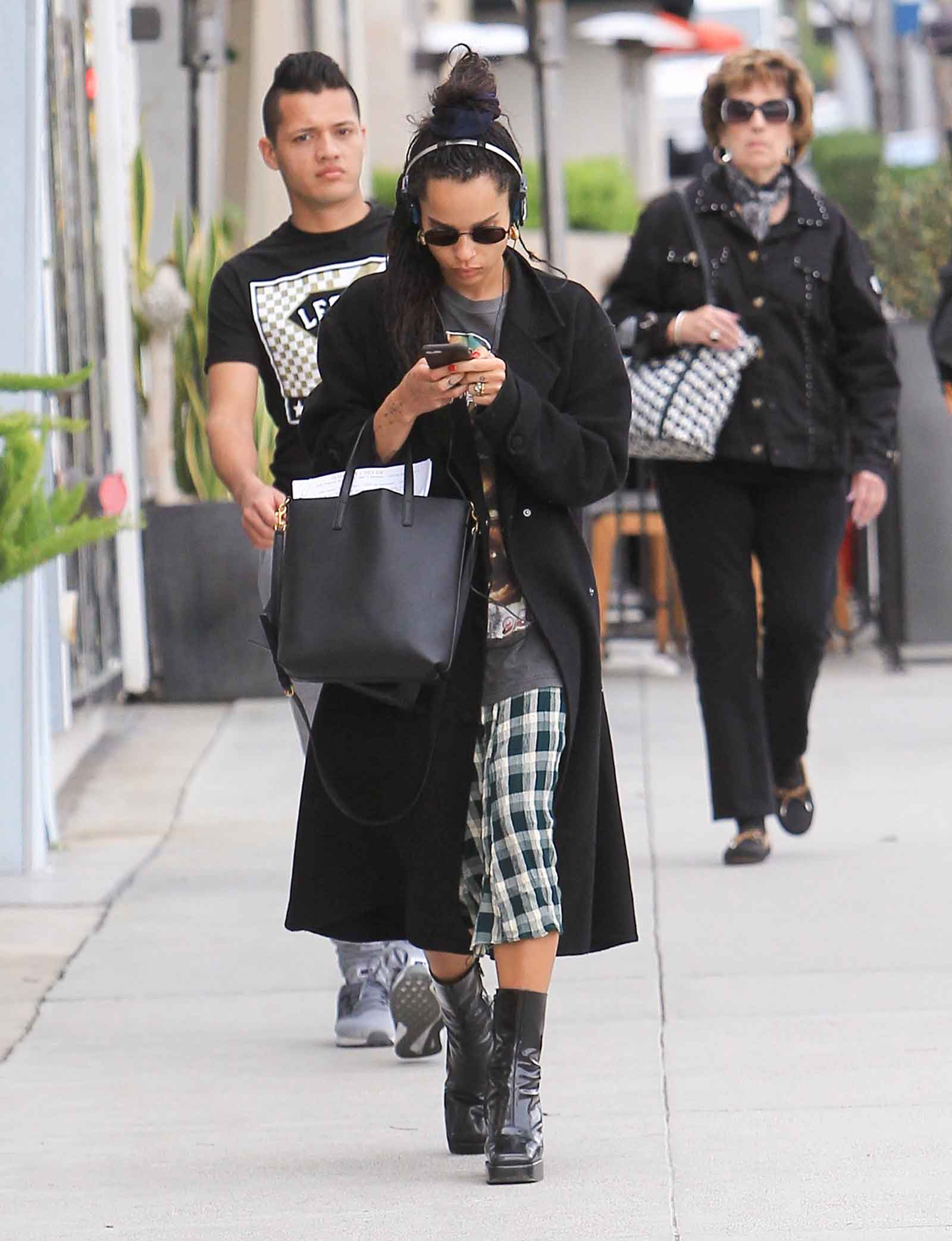 Zoe Kravitz in a plaid skirt and platform ankle boots