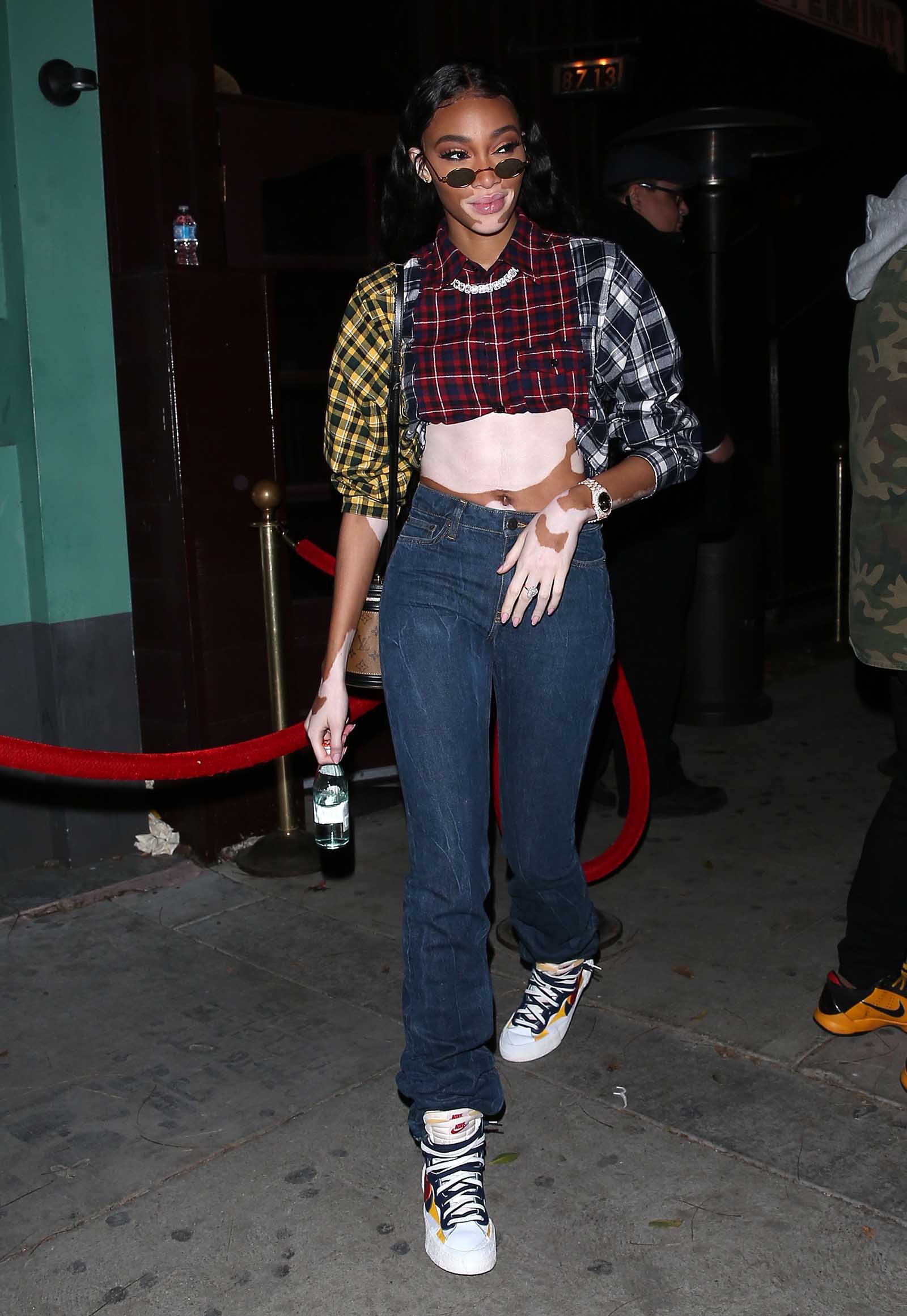 Winnie Harlow gives us 90's vibes in a patchwork flannel.